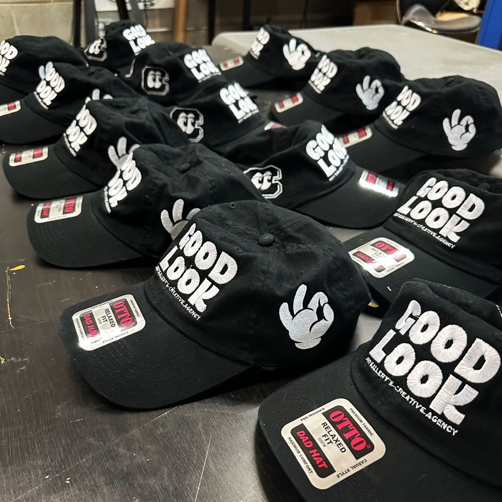 A run of custom embroidered caps, fresh off the machines
